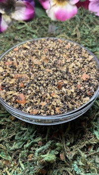 a bowl of pebbles on a green grass