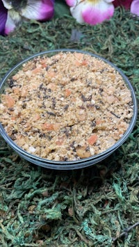 a bowl of granola sitting on top of a green grass