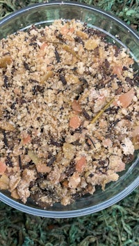 a bowl of granola sitting on top of grass